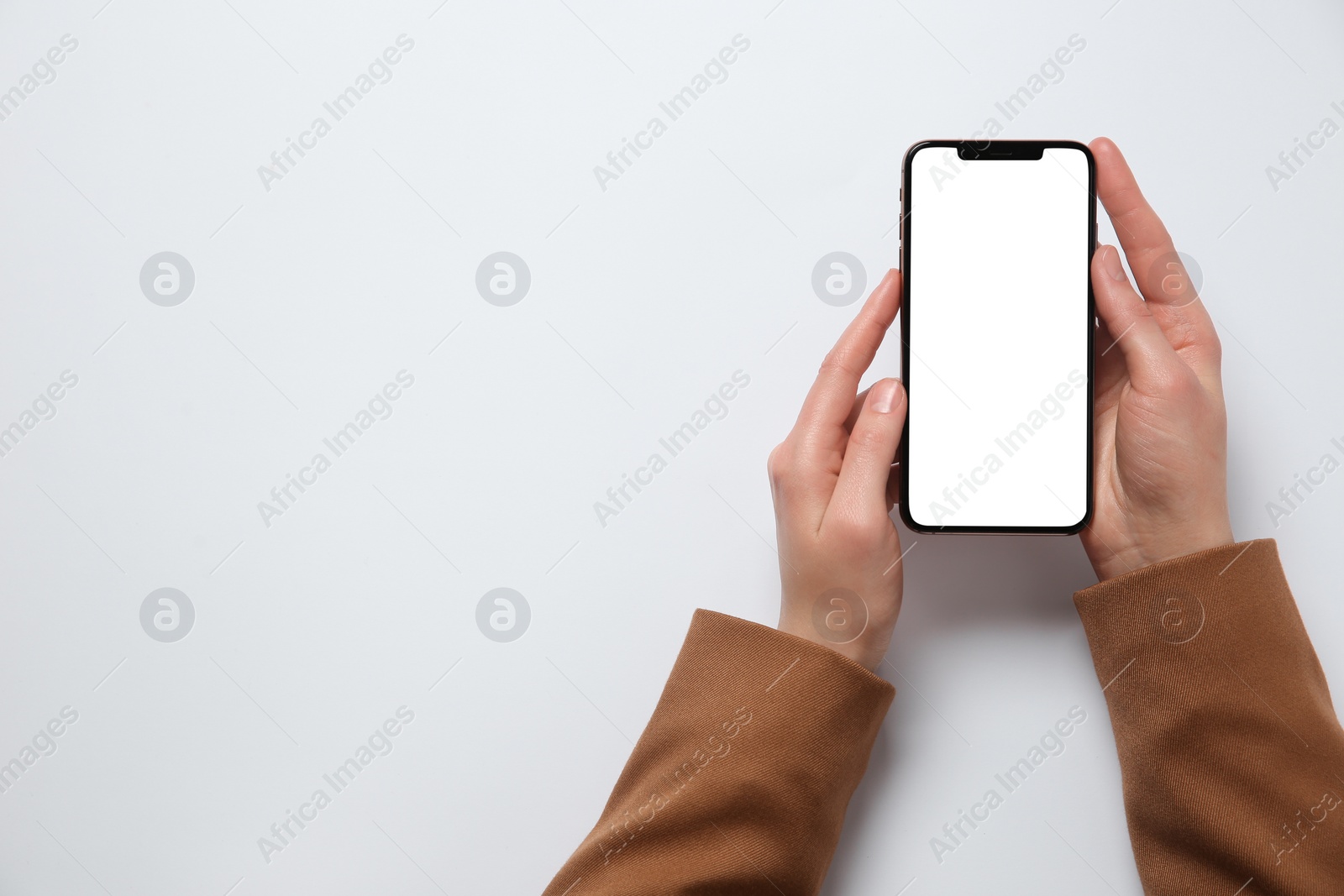 Photo of Woman with smartphone on white background, top view. Space for text