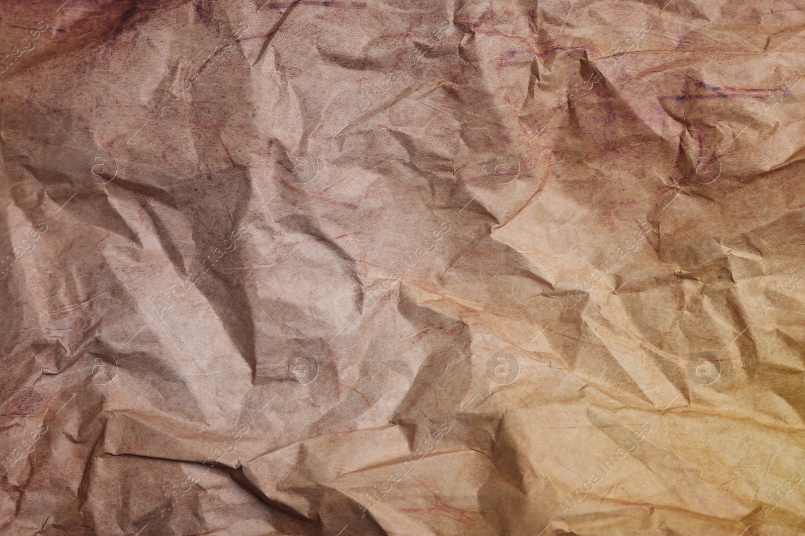 Photo of Texture of crumpled parchment paper as background, top view