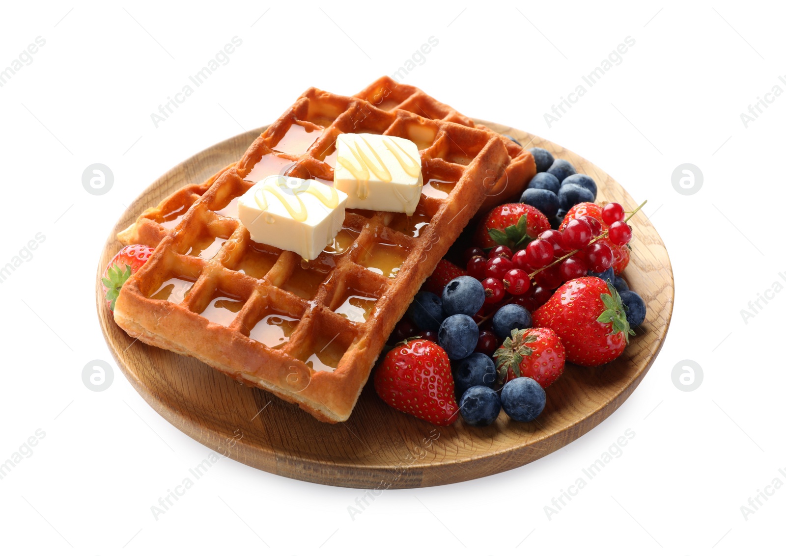 Photo of Plate of delicious Belgian waffles with honey, berries and butter isolated on white