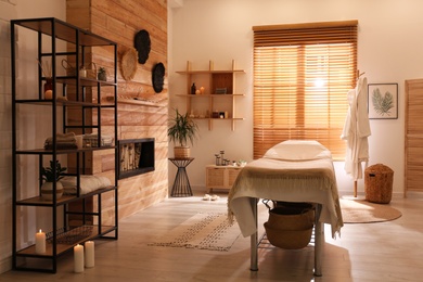 Stylish massage room interior in spa salon