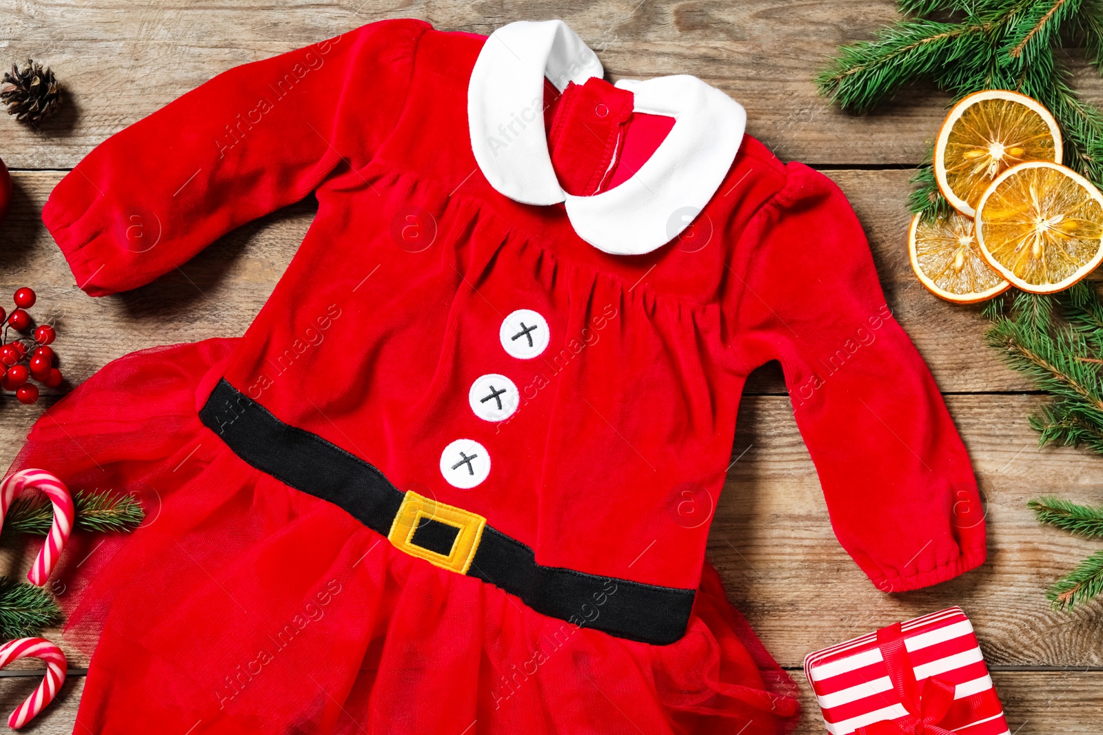 Photo of Flat lay composition with Christmas baby clothes on wooden background