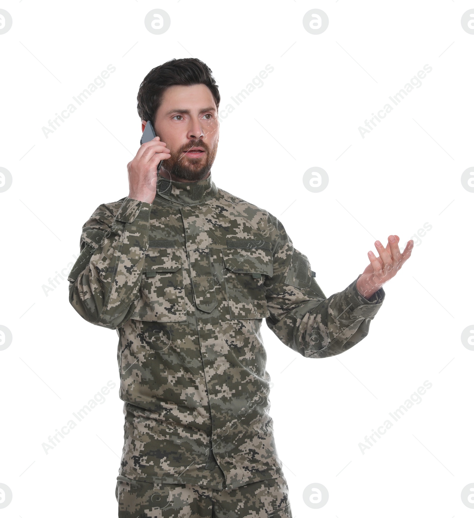 Photo of Emotional soldier talking on phone against white background. Military service