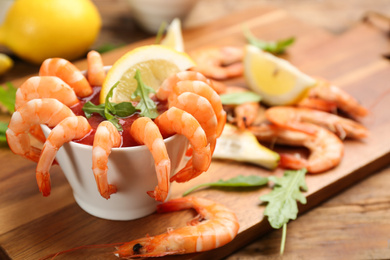 Photo of Delicious shrimp cocktail served on board, closeup