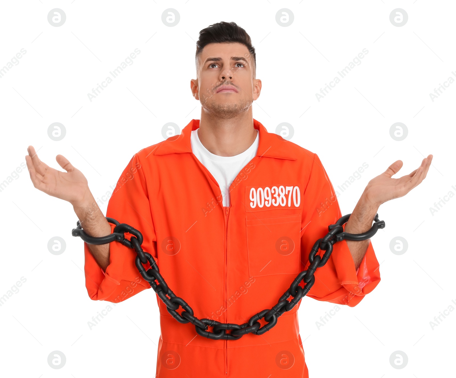 Photo of Prisoner in orange jumpsuit with chained hands on white background