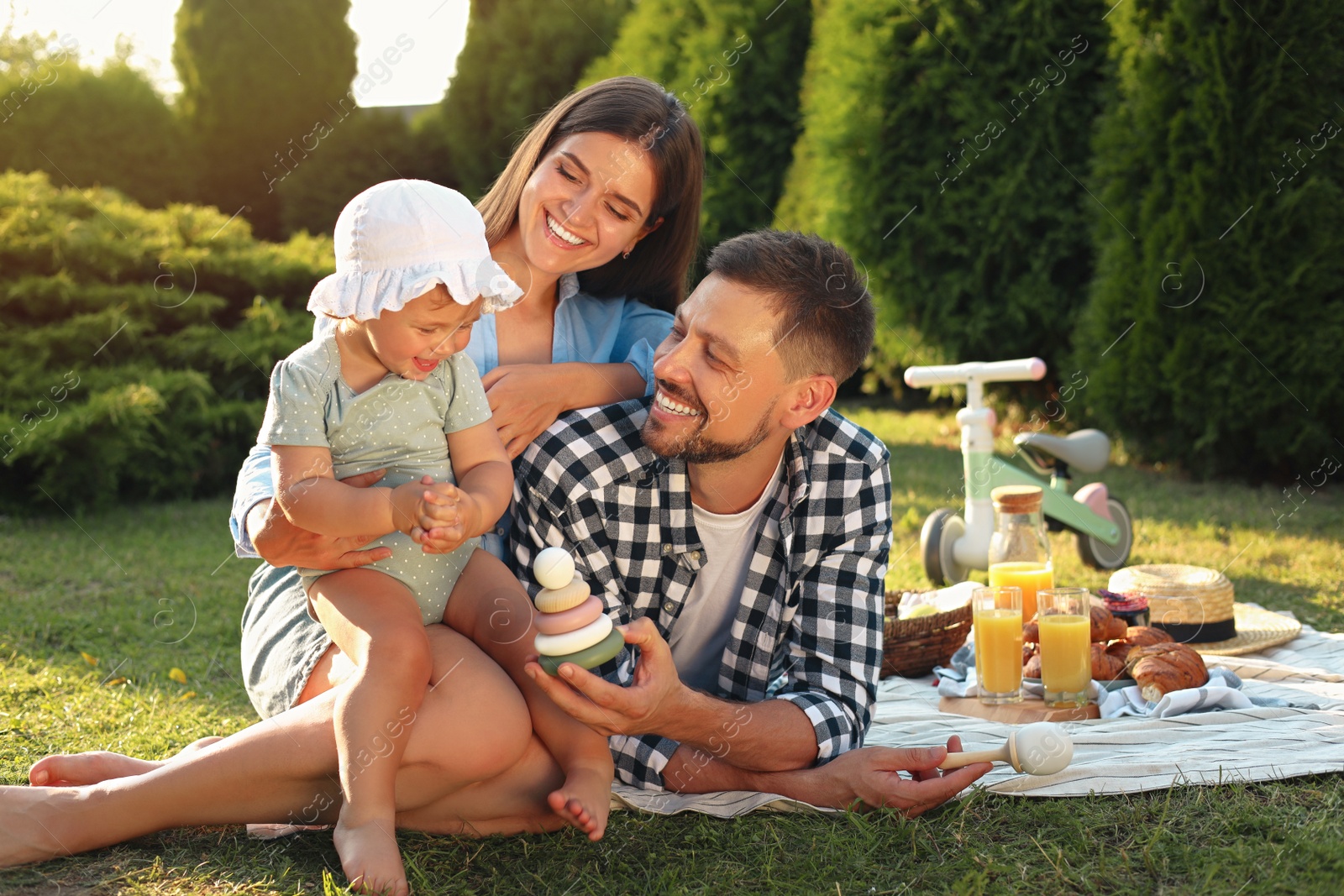 Photo of Happy family having picnic in garden on sunny day