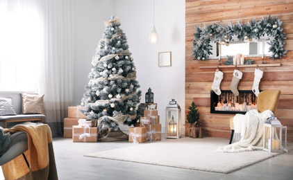 Photo of Festive interior with decorated Christmas tree and fireplace