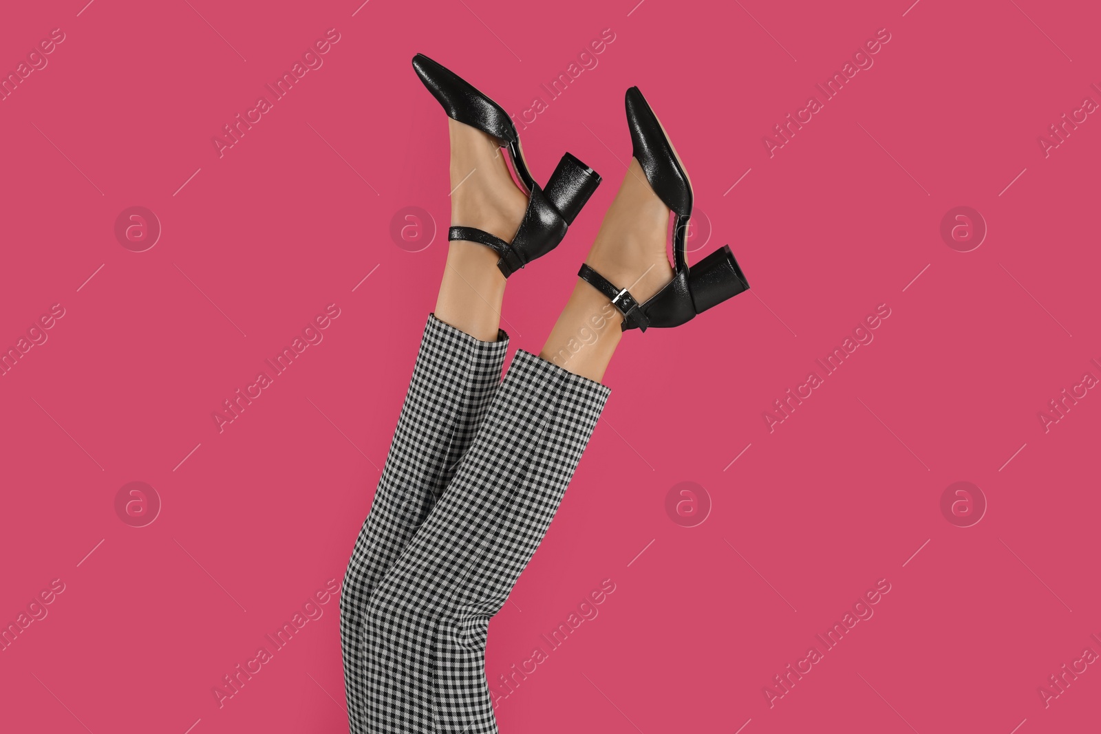 Photo of Woman wearing stylish shoes on pink background, closeup