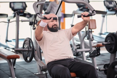 Overweight man training in gym