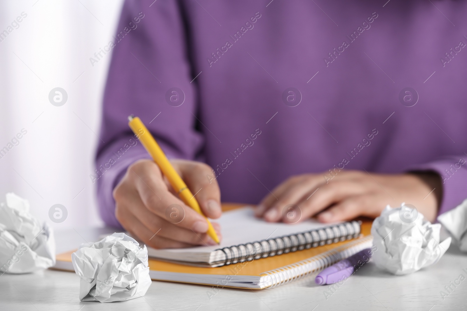 Photo of Woman working at table with crumpled paper, closeup. Generating idea