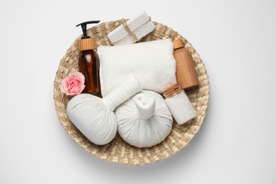 Photo of Beautiful spa composition with herbal massage bags and different care products on white background, top view