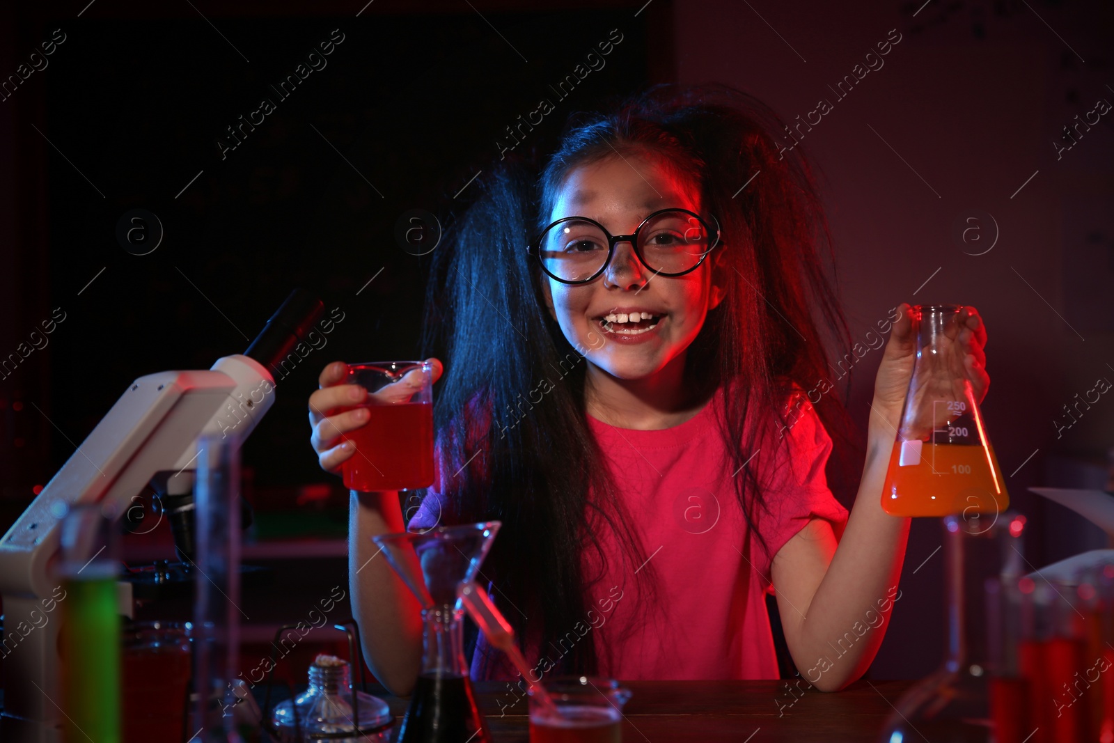 Photo of Child doing chemical research in laboratory. Dangerous experiment