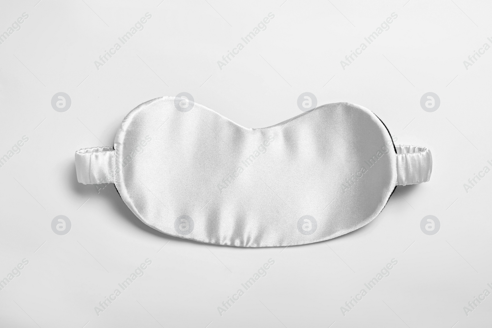 Photo of Sleeping mask isolated on white, top view. Bedtime accessory