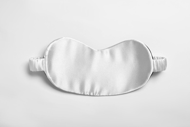 Photo of Sleeping mask isolated on white, top view. Bedtime accessory
