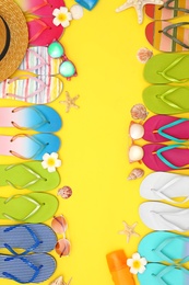 Photo of Flat lay composition with summer beach accessories on yellow background. Space for text