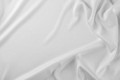 Photo of Texture of white silk ripple fabric as background, top view