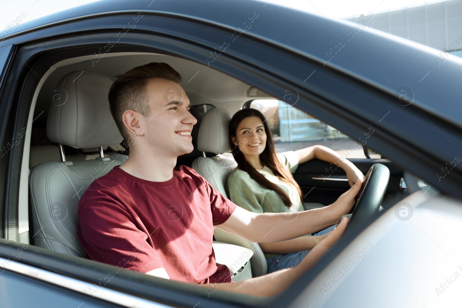 Photo of Happy young couple travelling together by car