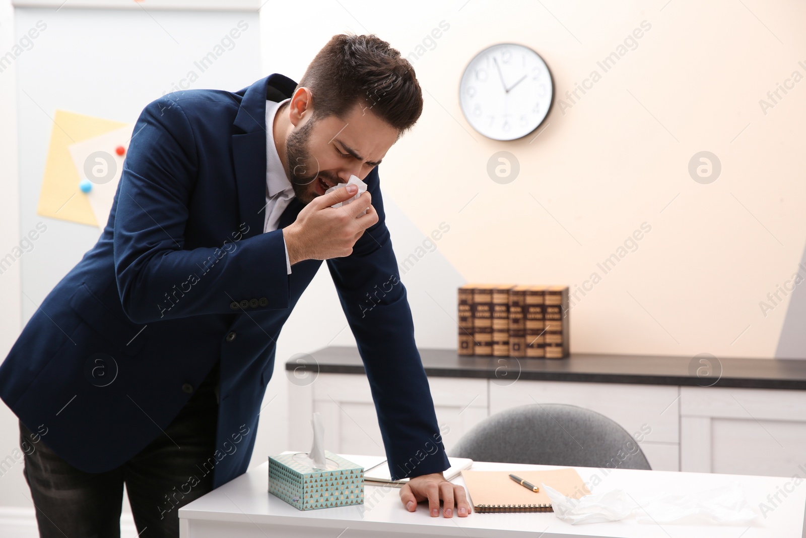 Photo of Sick young man at workplace. Influenza virus