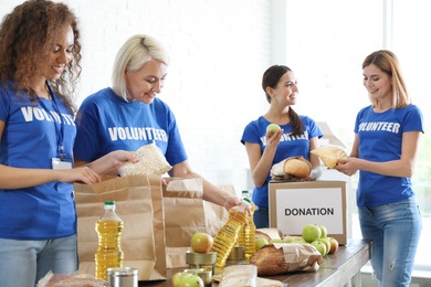 Photo of Team of volunteers collecting food donations indoors