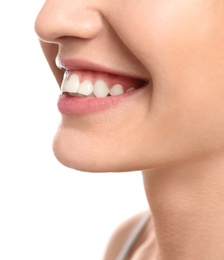 Young woman with beautiful smile on white background, closeup. Teeth whitening