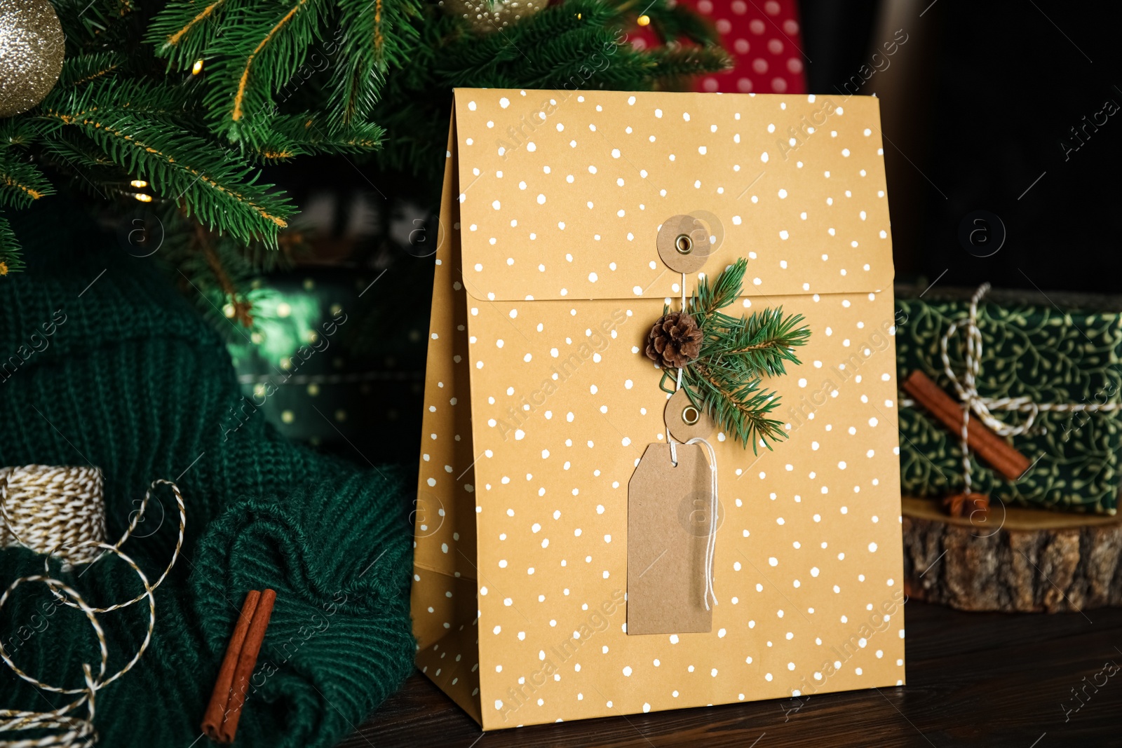 Photo of Composition with beautifully decorated Christmas present on wooden table