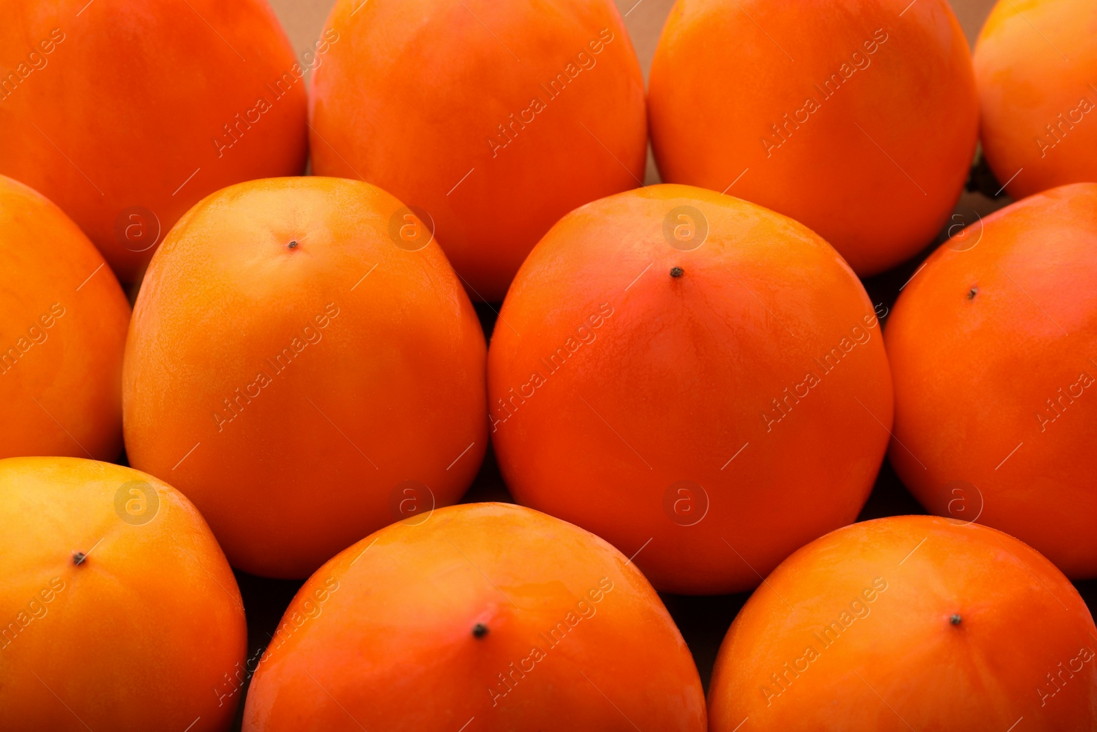 Photo of Pile of delicious ripe juicy persimmons as background, closeup