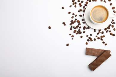 Breakfast with delicious wafers and coffee on white background, flat lay. Space for text