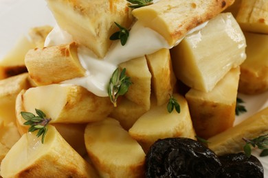 Photo of Tasty homemade parsnips with prunes and thyme as background, closeup