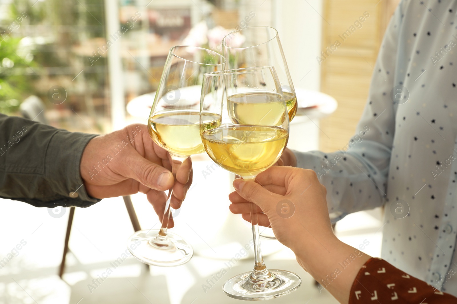 Photo of People with glasses of wine on blurred background, closeup