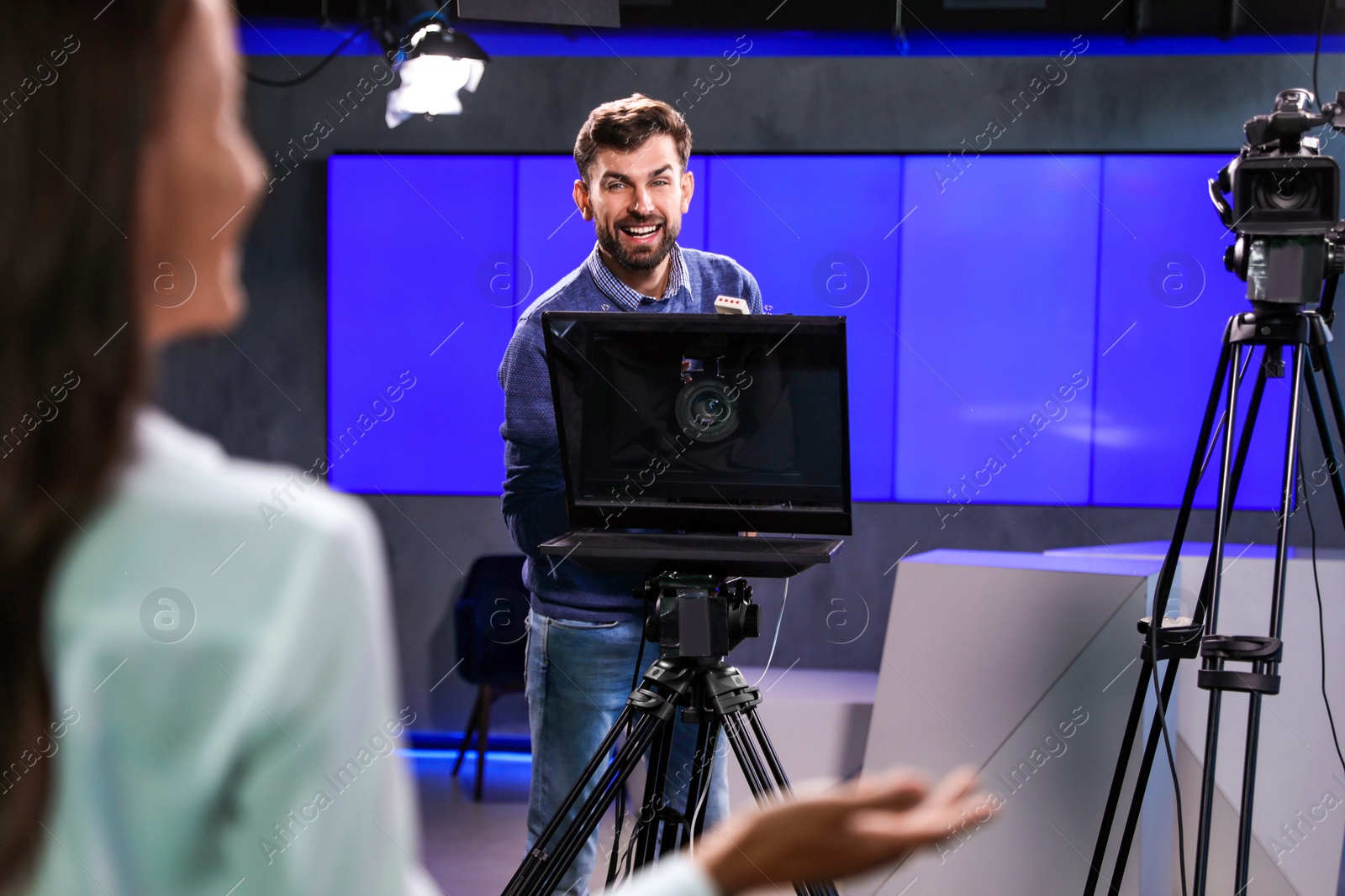 Photo of Professional video camera operator working in studio