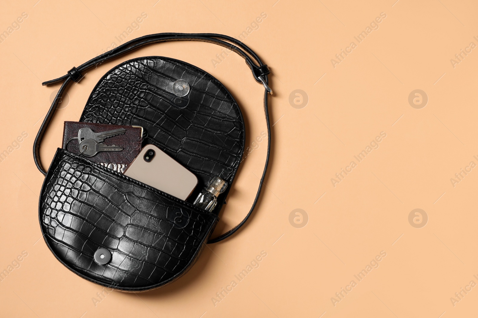 Photo of Flat lay composition with stylish woman's bag on beige background. Space for text