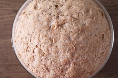 Fresh sourdough in bowl on wooden table, top view