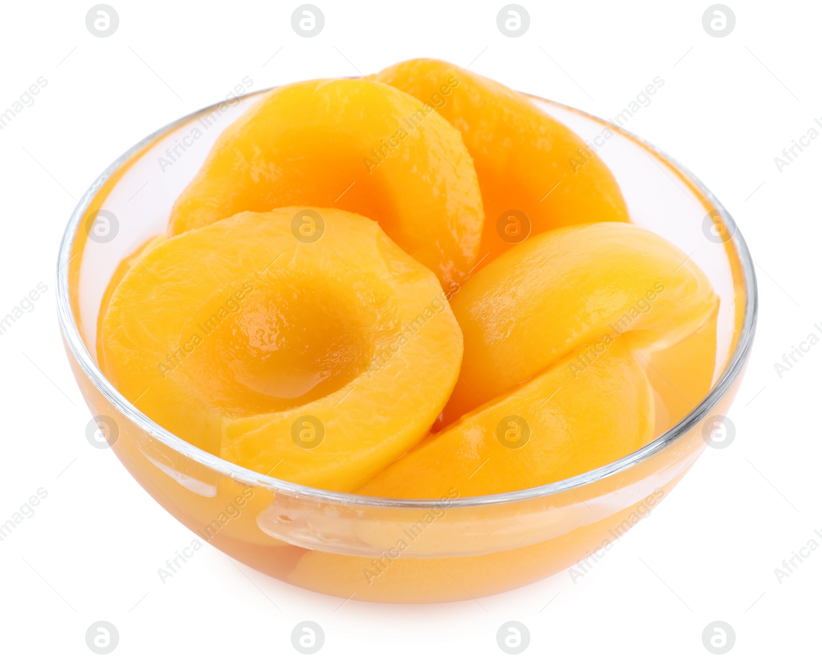 Photo of Halves of canned peaches in bowl isolated on white