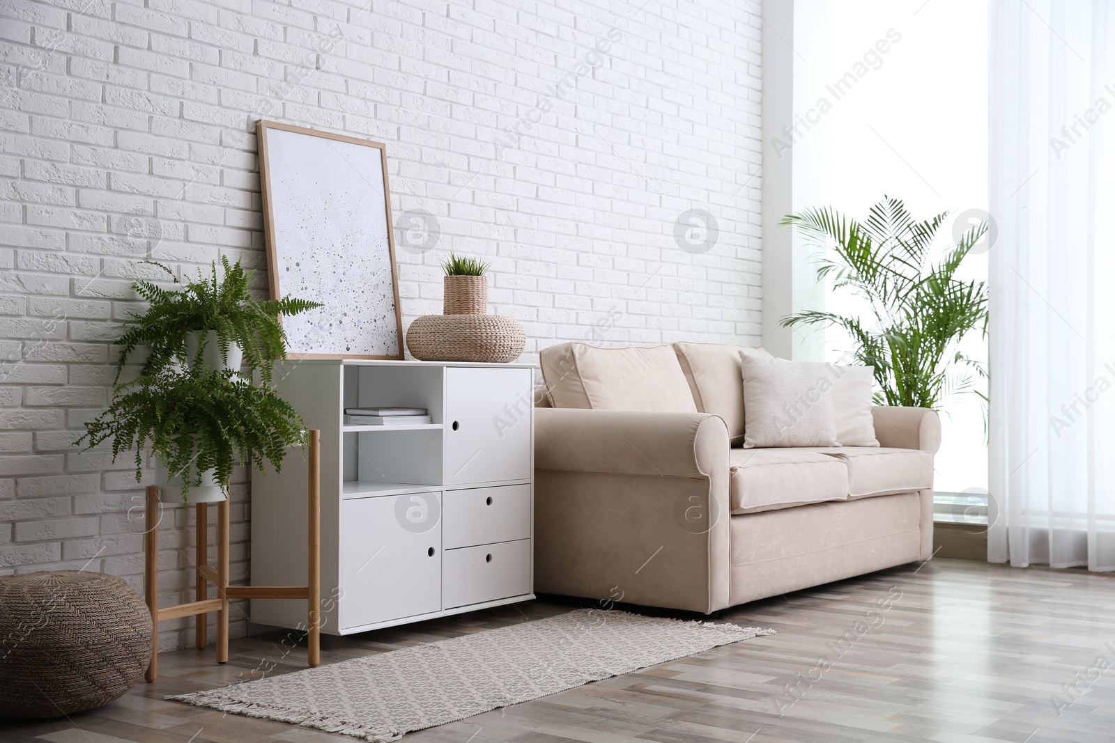 Photo of Modern room interior with stylish white cabinet