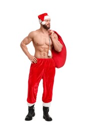 Photo of Muscular young man in Santa hat holding bag with presents on white background