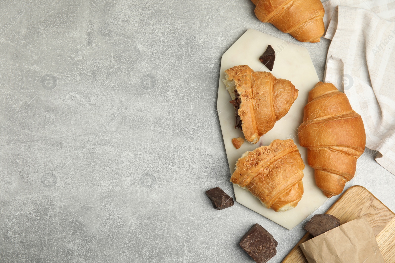 Photo of Flat lay composition with tasty croissants and chocolate on light grey table. Space for text