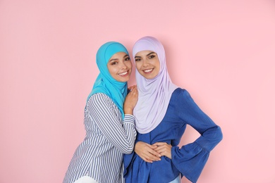 Photo of Portrait of young Muslim women in hijabs against color background