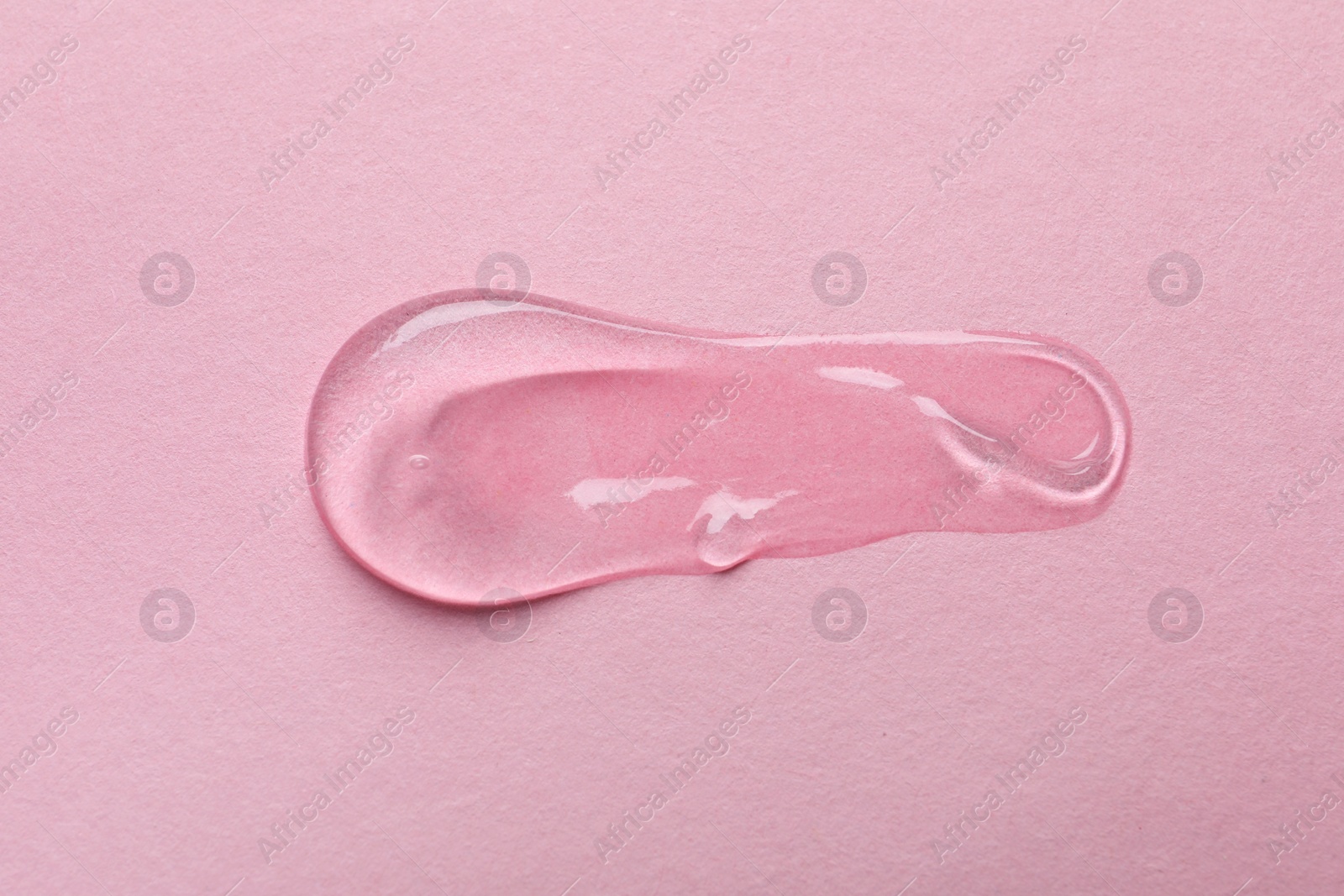 Photo of Swatch of cosmetic gel on pink background, top view