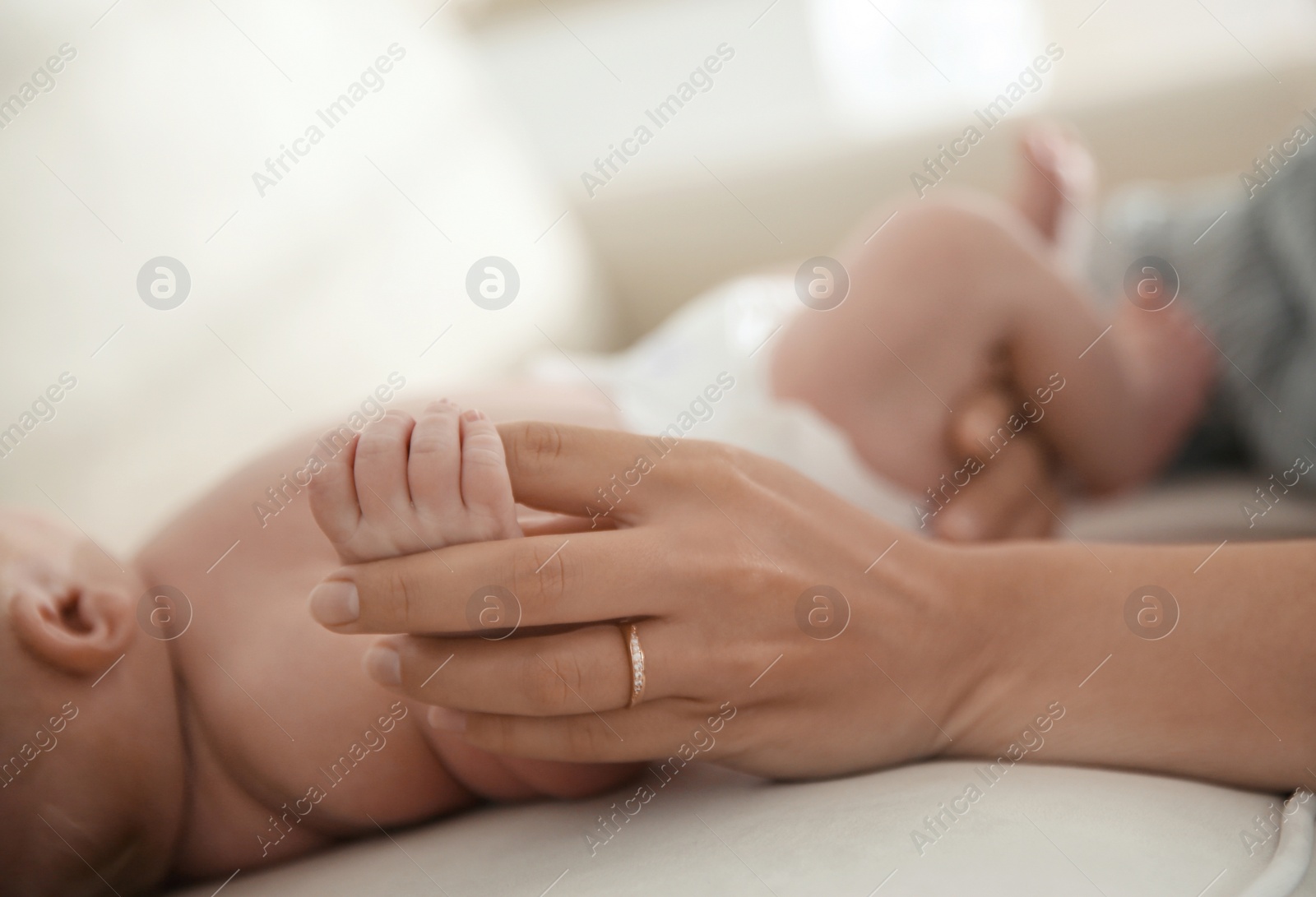 Photo of Mother with her newborn baby at home, closeup