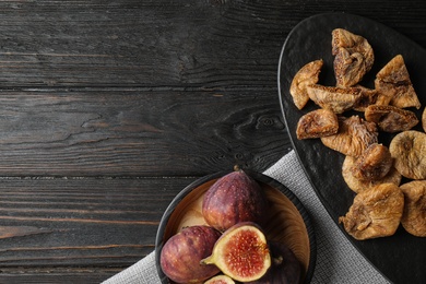 Photo of Tasty dried and raw figs on black wooden table, flat lay. Space for text