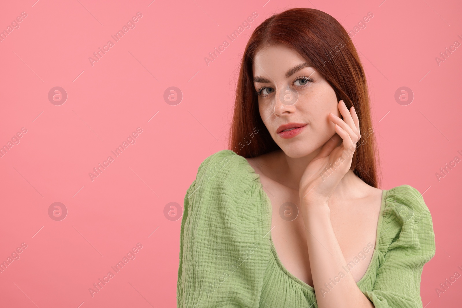 Photo of Portrait of beautiful woman with freckles on pink background. Space for text