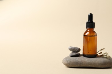 Photo of Composition with bottle of cosmetic serum on beige background. Space for text