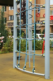 Photo of Net climbing wall on outdoor playground in residential area