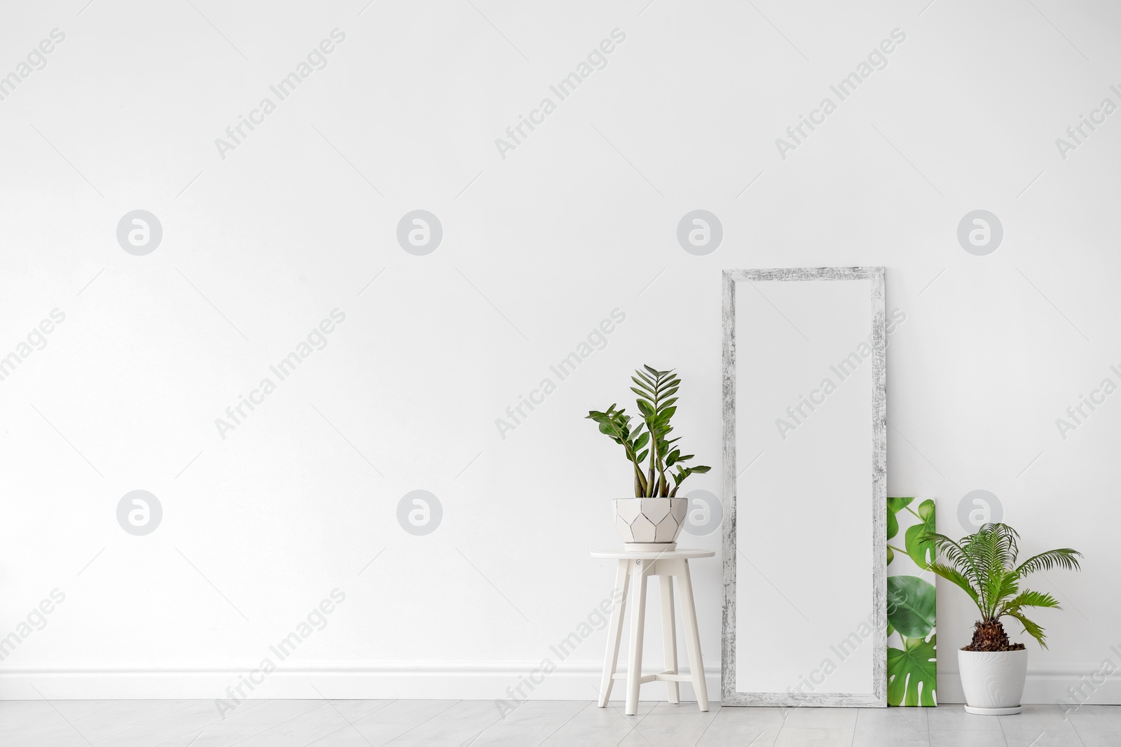 Photo of Modern interior with large stylish mirror with tropical plants