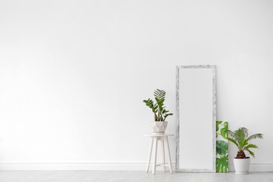 Photo of Modern interior with large stylish mirror with tropical plants