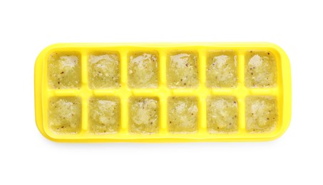 Photo of Puree in ice cube tray on white background, top view. Ready for freezing