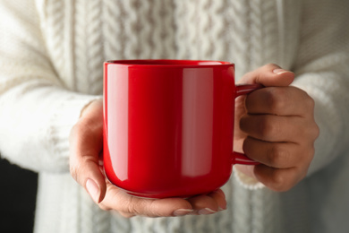 Photo of Woman holding cup of hot winter drink, closeup