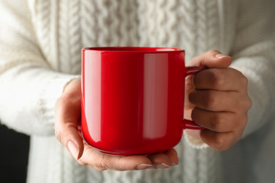 Woman holding cup of hot winter drink, closeup