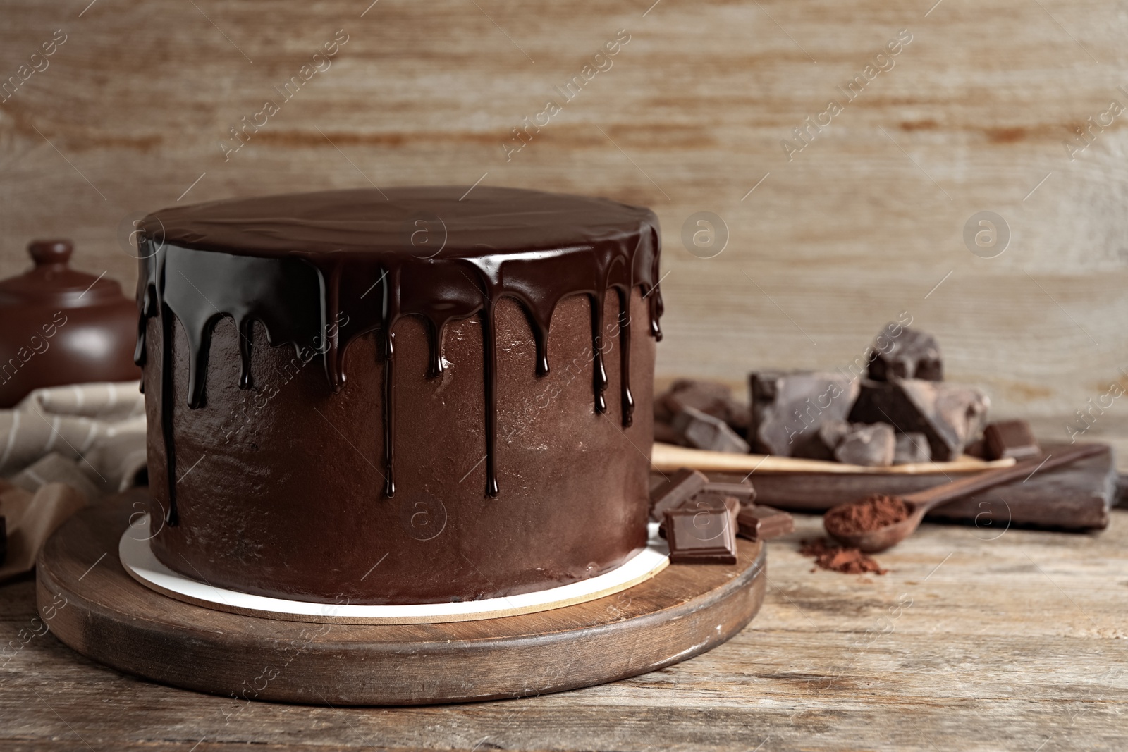 Photo of Freshly made delicious chocolate cake on wooden table. Space for text