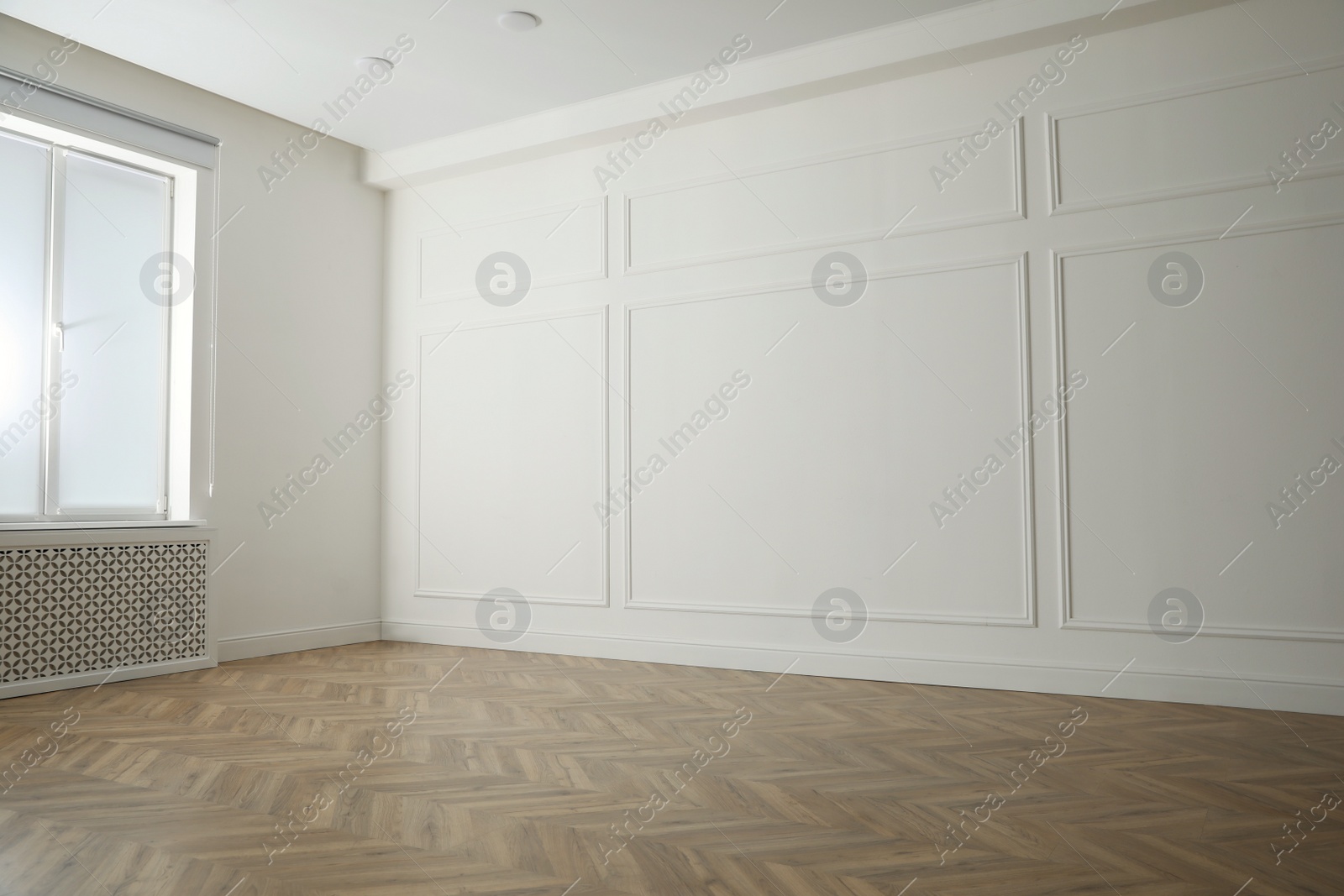 Photo of Parquet floor in light spacious empty room