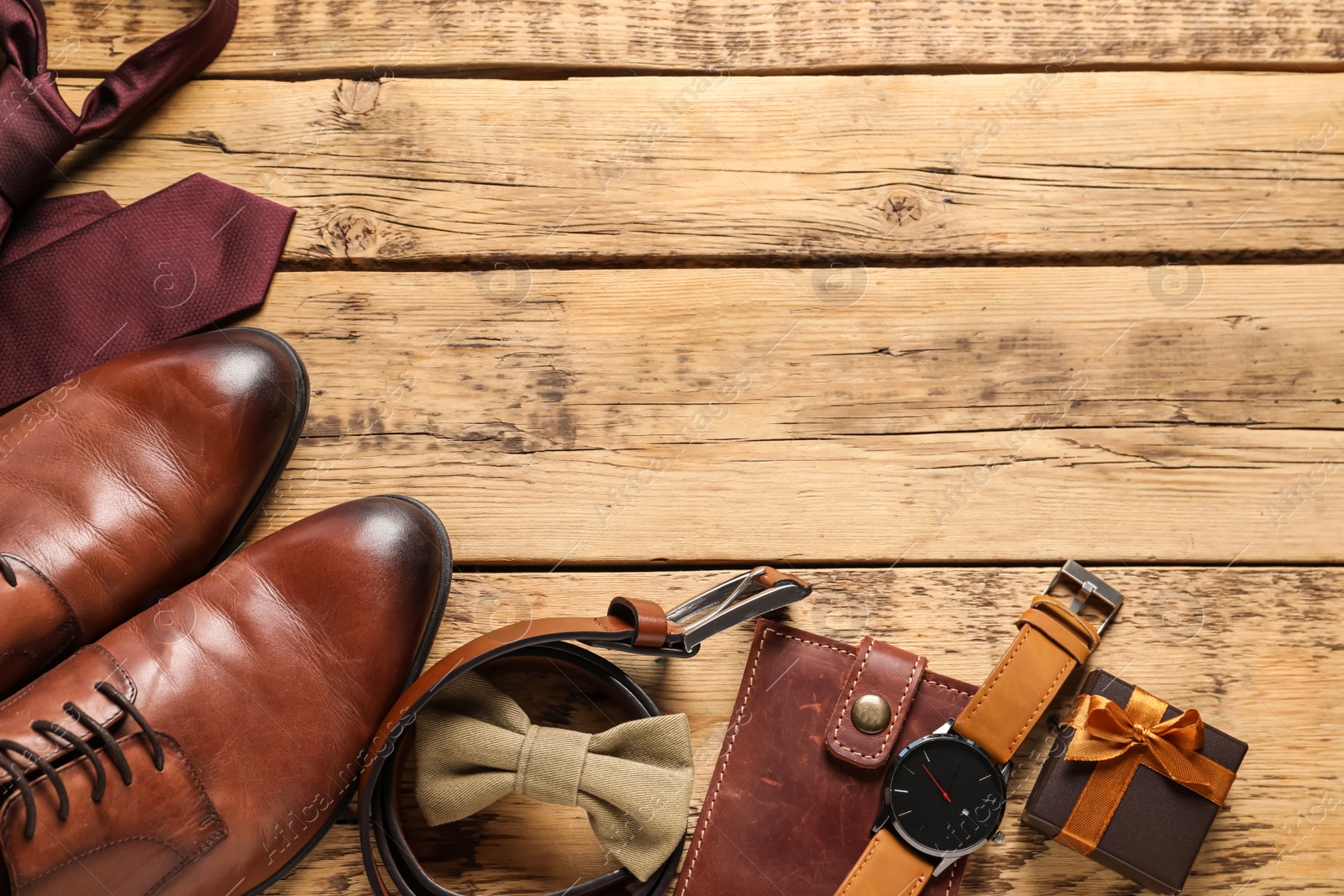 Photo of Shoes, gift box and different men accessories on wooden background, flat lay with space for text. Father's day celebration